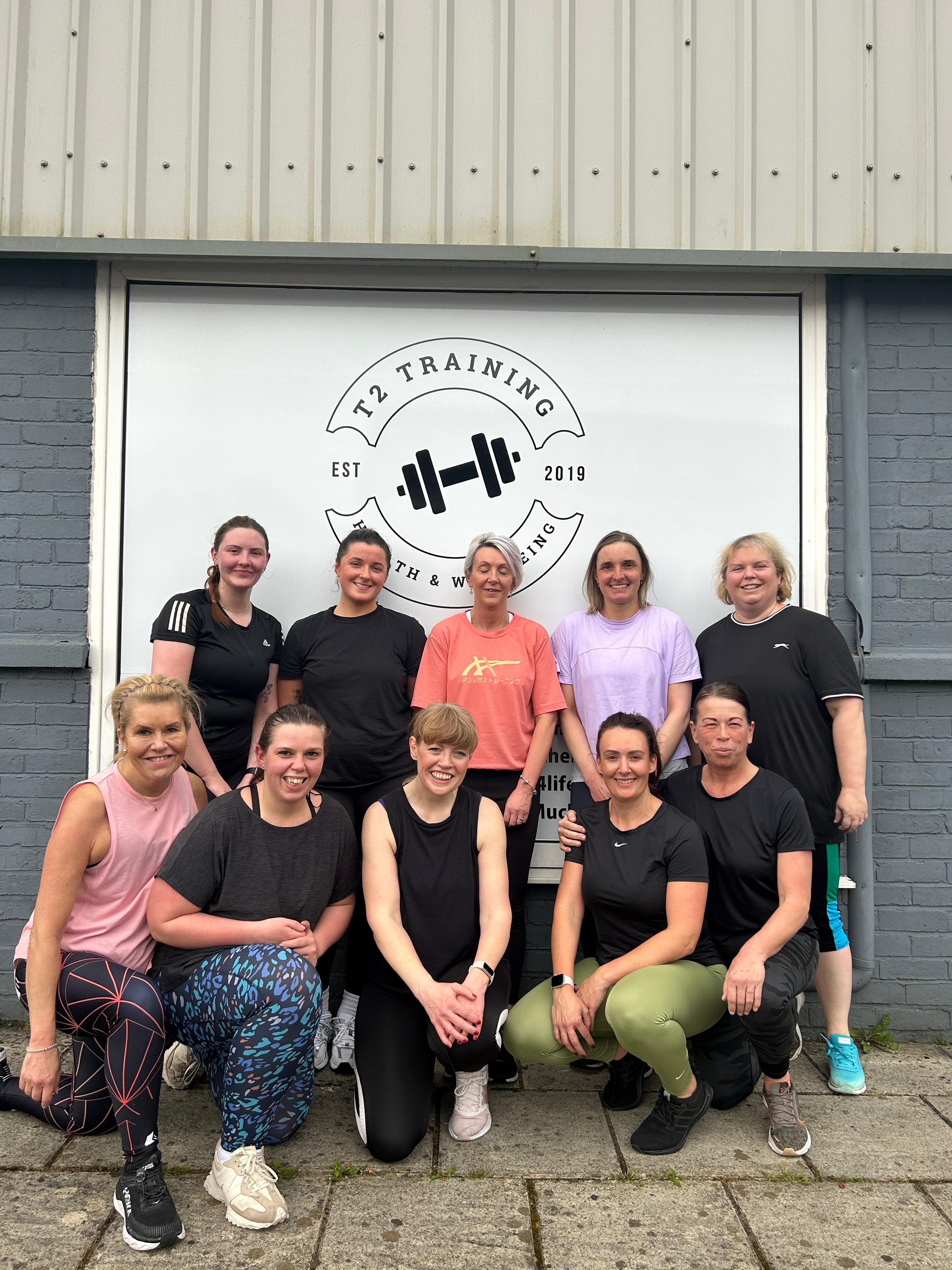 Clients smiling together outside T2 gym
