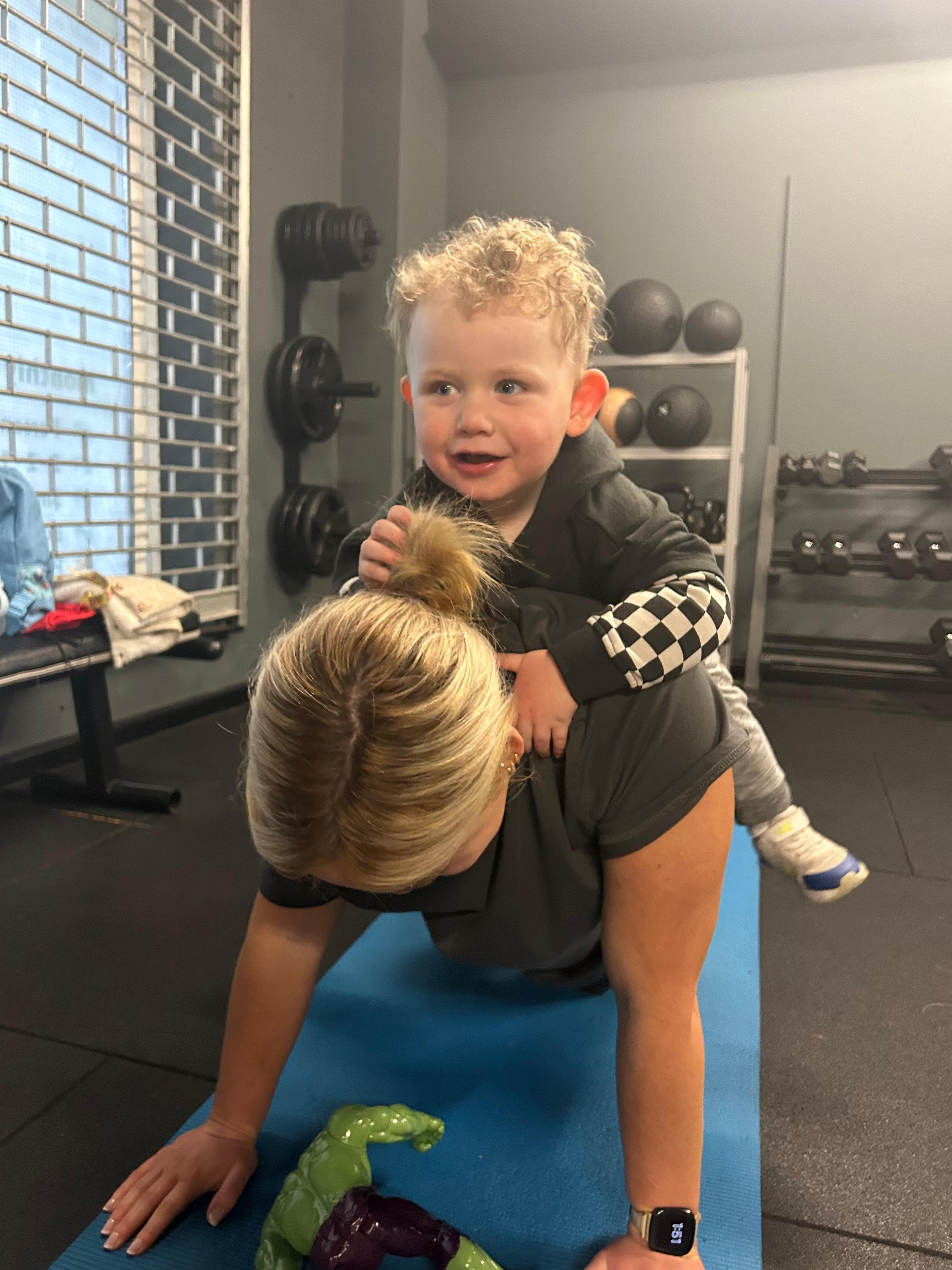 Mother and baby fitness class with toddler