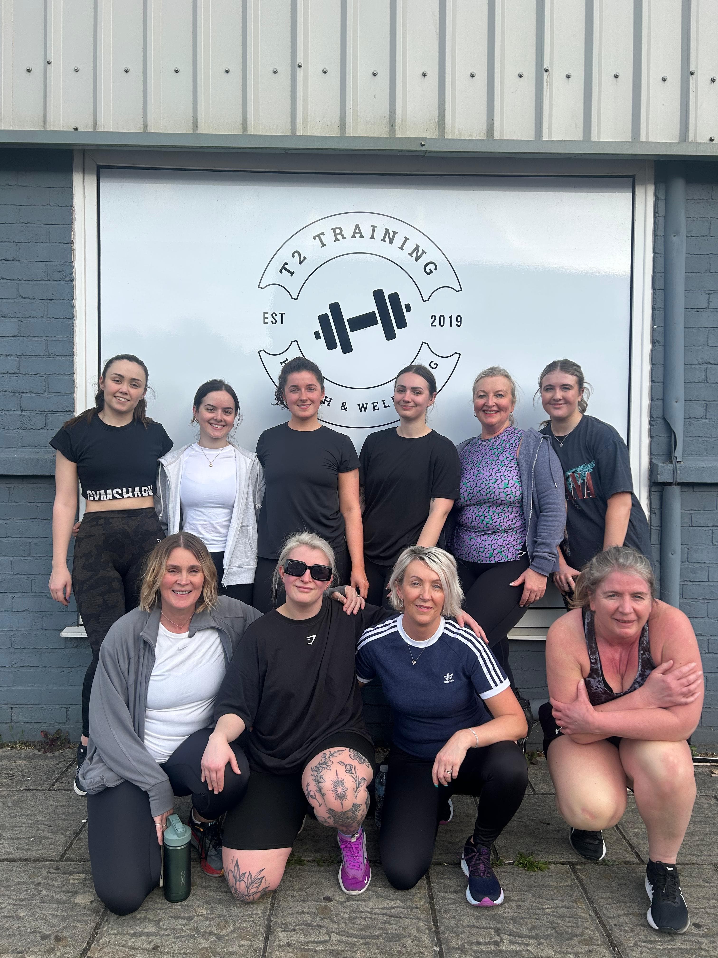 Outdoor group photo of happy T2 clients