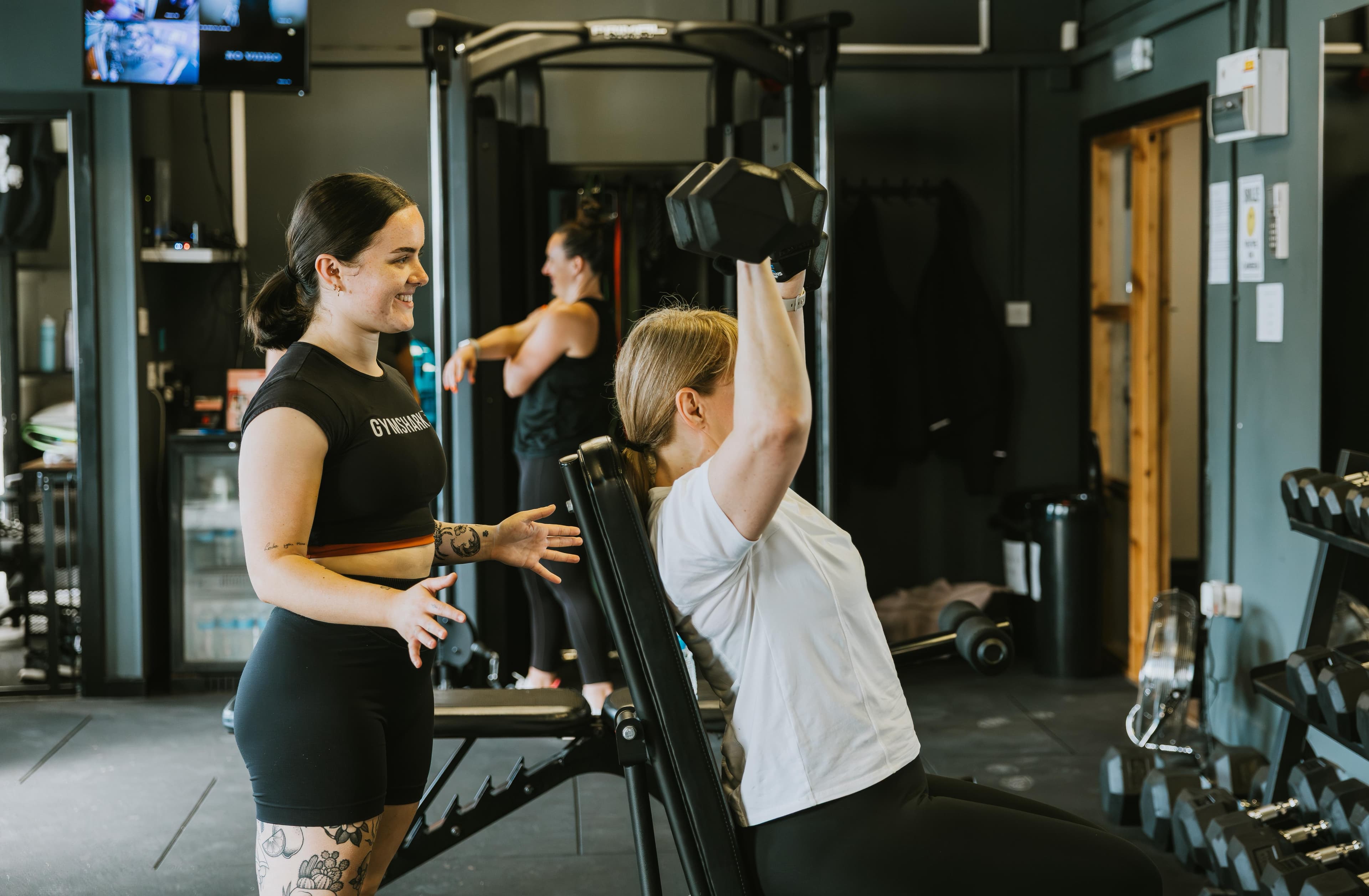 Tamzin smiling while coaching personal training client