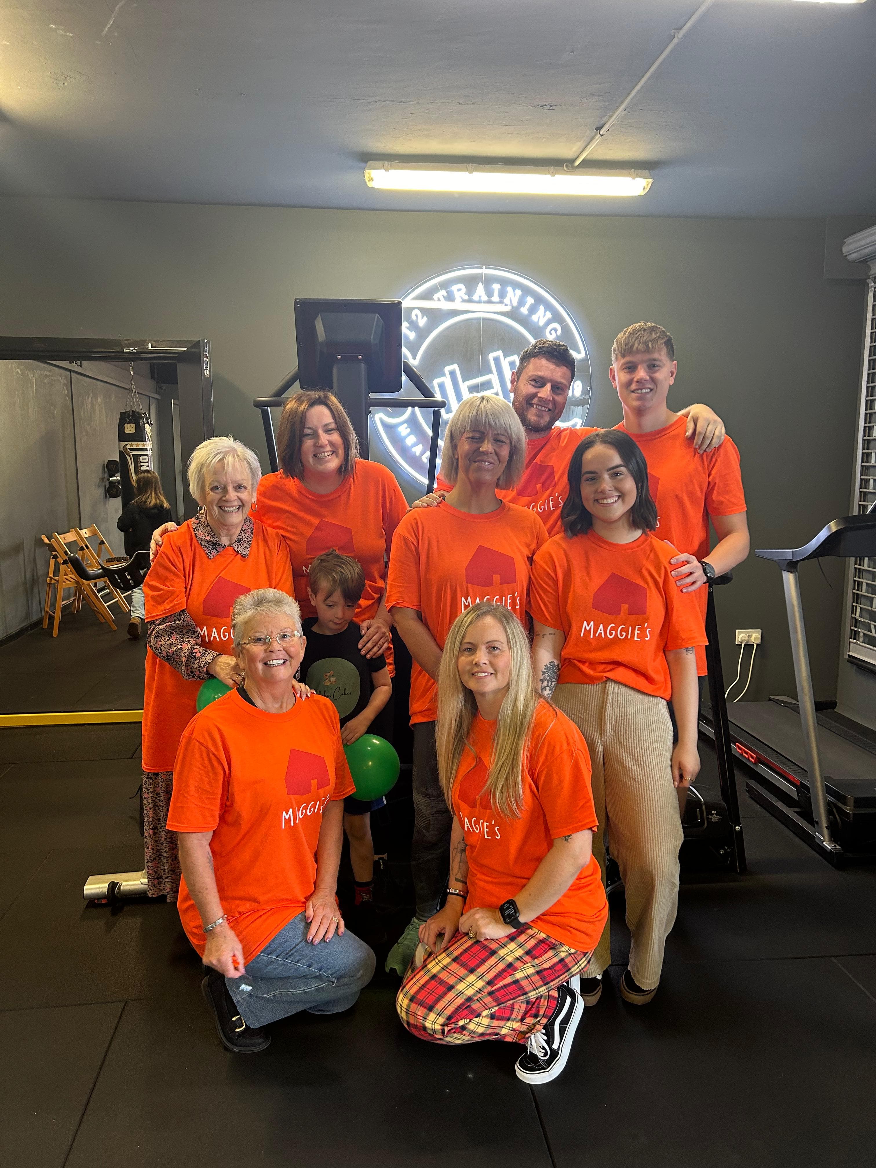 T2 members wearing Maggie's charity t-shirts