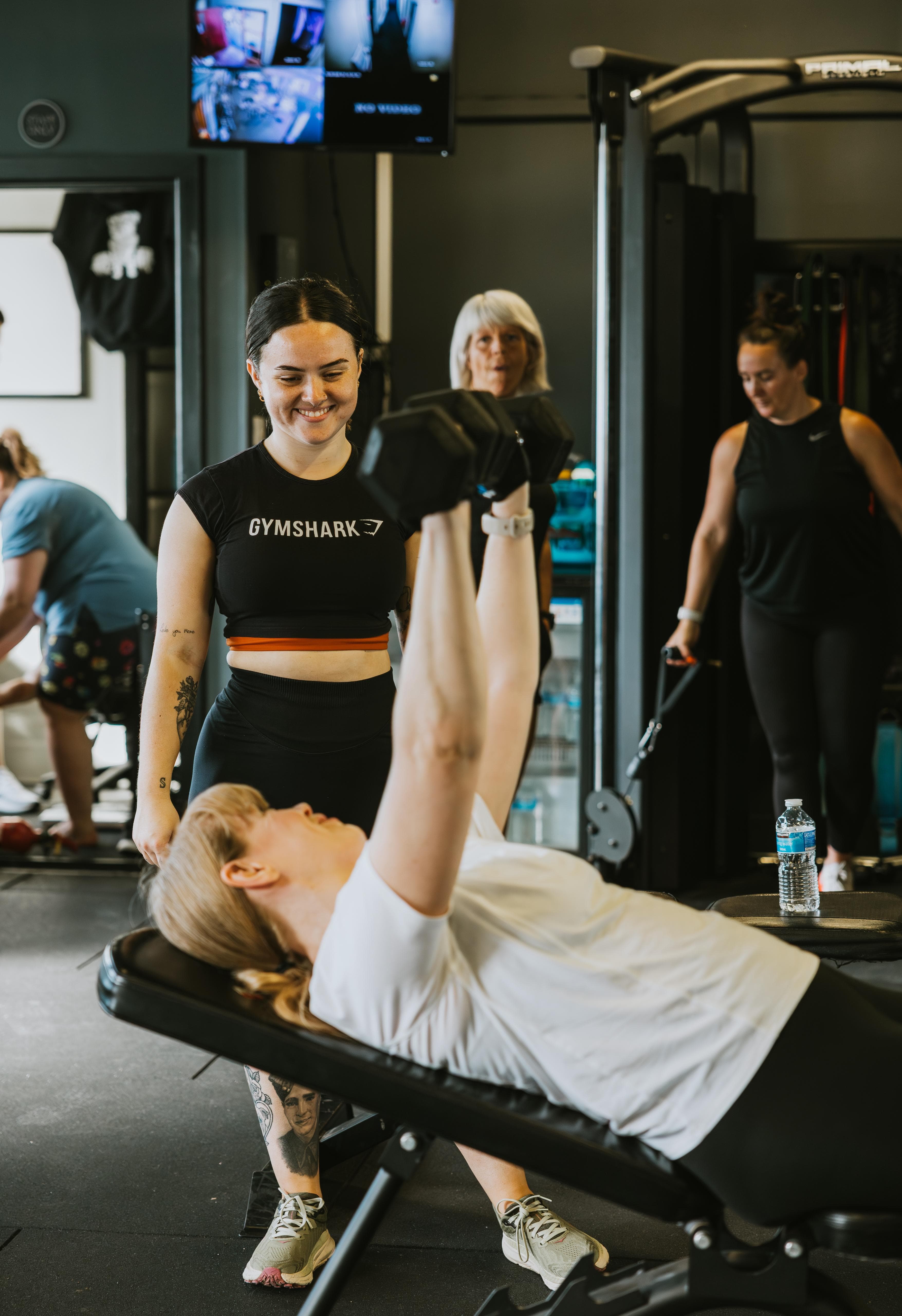 Tamzin coaching client on weights bench